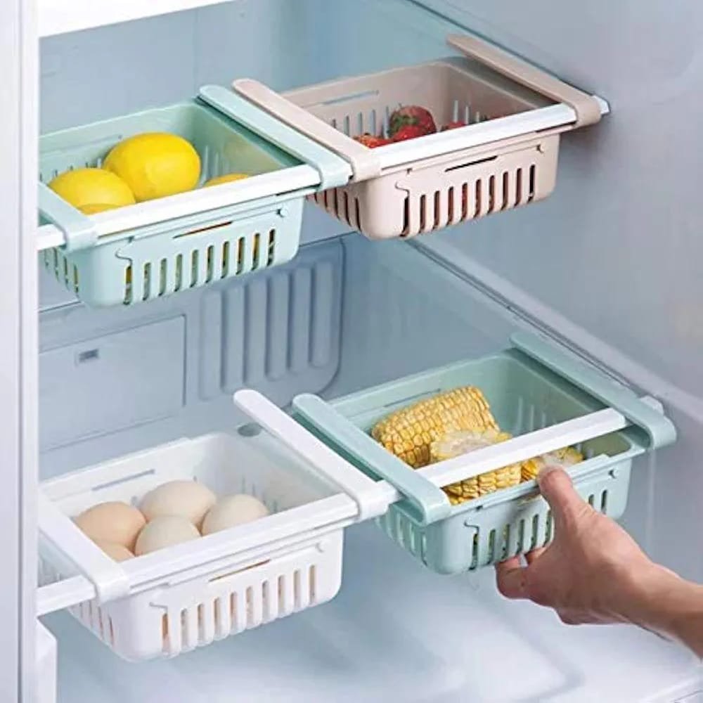 2026/05/1002028449.jpg Adjustable Fridge Storage Basket clipped onto a refrigerator shelf containing fresh vegetables