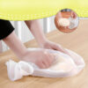 Hands pressing and smoothing bread dough inside a white Silicone Kneading Dough Bag