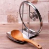 Lid and Spoon Stand Holder Stainless Steel holding a metal pot cover and a soup ladle