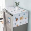 Waterproof refrigerator top dust cover with hanging side storage pockets for kitchen utensils.