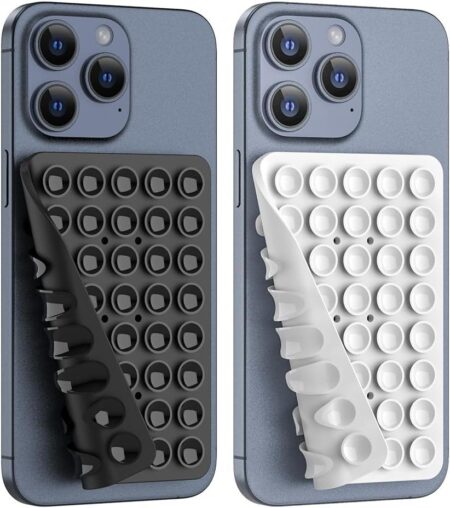 Washable reusable double sided suction pad holding a phone on a mirror surface