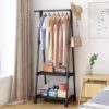 Triangle coat hanger rack and removable clothes floor stand in a bedroom corner