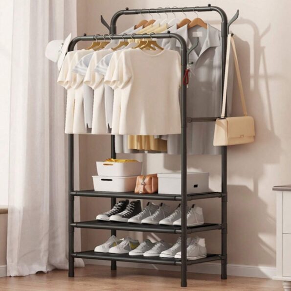 Double pole freestanding coat hat rack with 3 shelves holding clothes and shoes in a bedroom