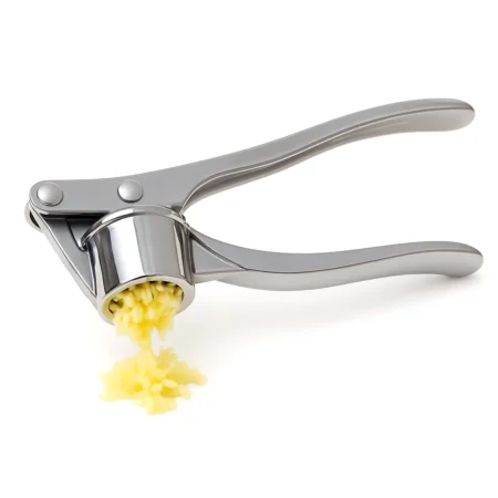 Heavy-duty stainless steel garlic press crushing fresh garlic cloves in kitchen